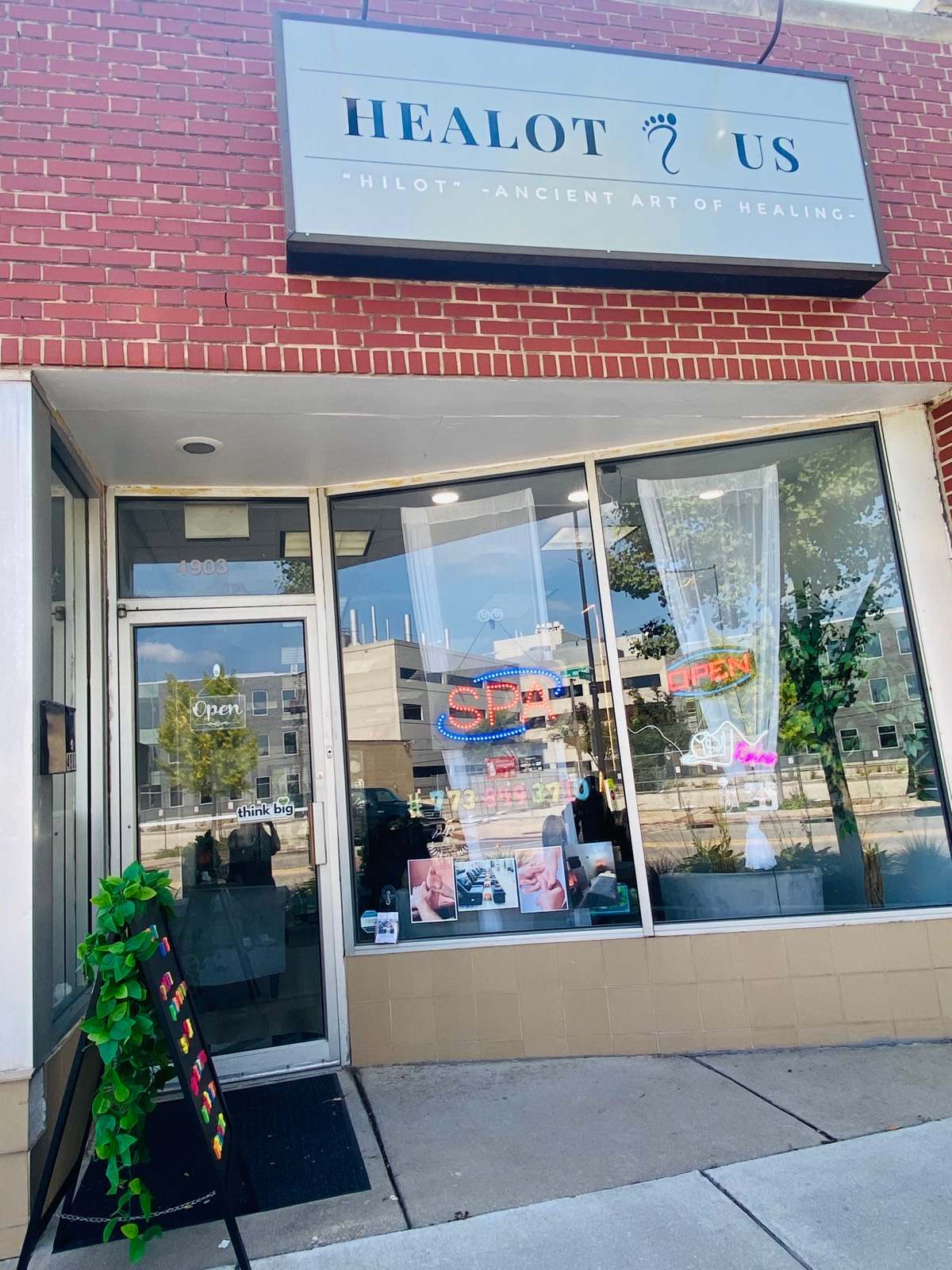The Healot R Us storefront at 4903 Oakton Street in Skokie, with its blue sign and open door.